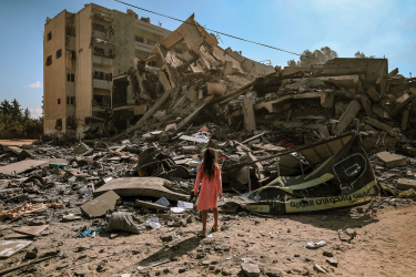 Pige foran bygning i ruiner, Gaza