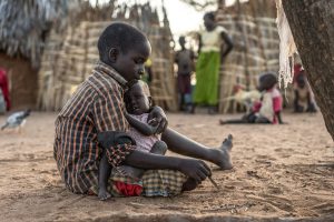 This is a story about the love between two brothers – Leolida, 12, and Lawrence, aged just 18 months. It shows how by sticking together, families can survive the toughest of times, especially when they get the support they need. 

Leolida adores little Lawrence. He plays with him and looks after him when mum Jennifer is cooking or cleaning. He even shares his food with him. This would be a difficult thing for any child to do for his sibling, but it’s even more admirable when you consider Leolida often goes to bed hungry as a result.

“Lawrence is my little brother that I love very much and I would do anything to help him,” says Leolida. The feeling is entirely mutual – Lawrence really misses Leolida when he goes to school and comes alive when he gets home. Leolida scoops him up in his arms and kisses him. He plays with him constantly, clapping hands, and throwing him up in the air. It’s the only time that Lawrence smiles or laughs.

Leolida believes that playing helps to distract Lawrence from his hunger. “He is not hungry when you play with him, he is just happy" says Leolida. 

Thanks to an innovative new Save the Children programme, Leolida and his mum haven’t had to cope with Lawrence’s illness alone. One of our community health volunteers, Mark, was on hand to diagnose little Lawrence and give him the antibiotics and highly nutritious food he needed to begin his recovery. 

As well as helping Lawrence get well again, Mark has also inspired Leolida’s new career aspiration. “I want to become a doctor so that I can help other young children like my younger brother Lawrence,” he says.

A full case study for Leolida &amp; Lawrence is available (with a section on CHV Mark).